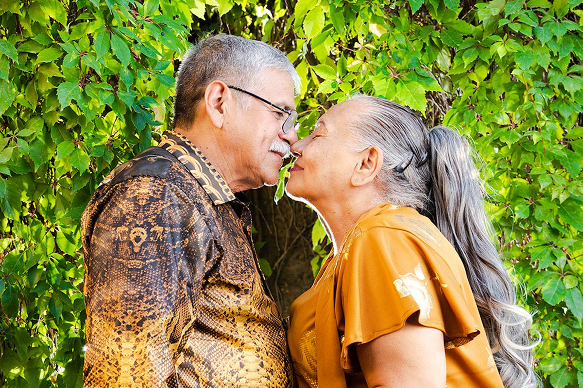 Un couple de seniors s’embrasse dans un jardin